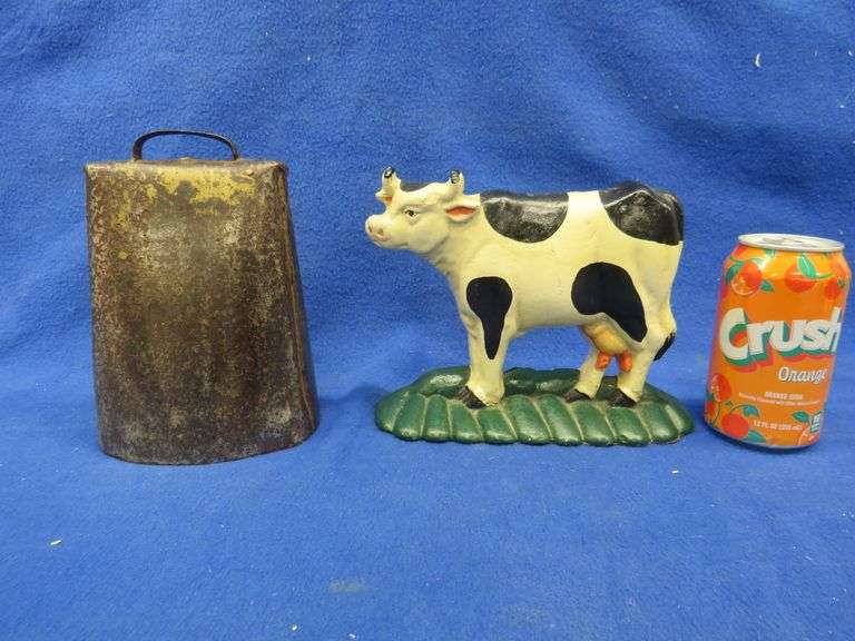 Vintage cowbell and a cast iron doorstop AAA Auction and Realty
