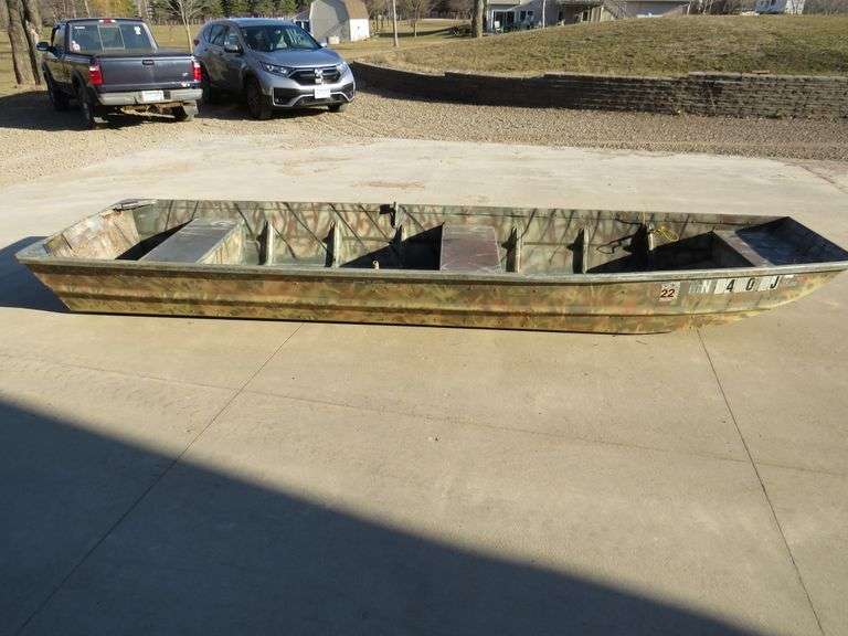 14' Alumacraft Jon boat with three seats and an anchor. Missing one