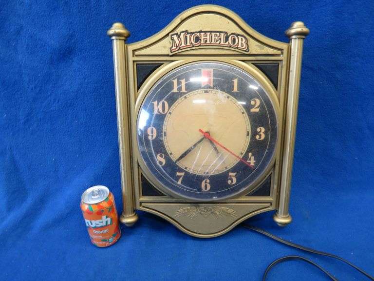 Michelob wall clock. Lights up and runs. Damage to clock covering