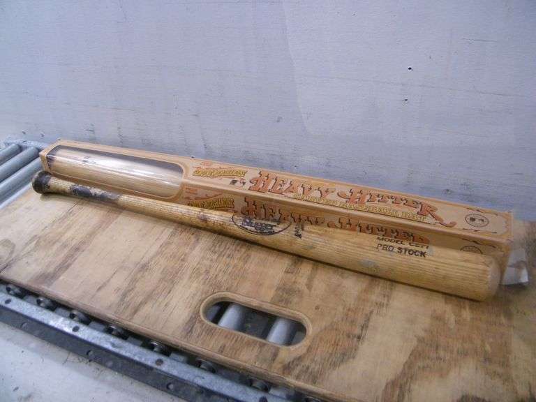 Heavy hitter carved baseball bat and Louisville Slugger baseball bat