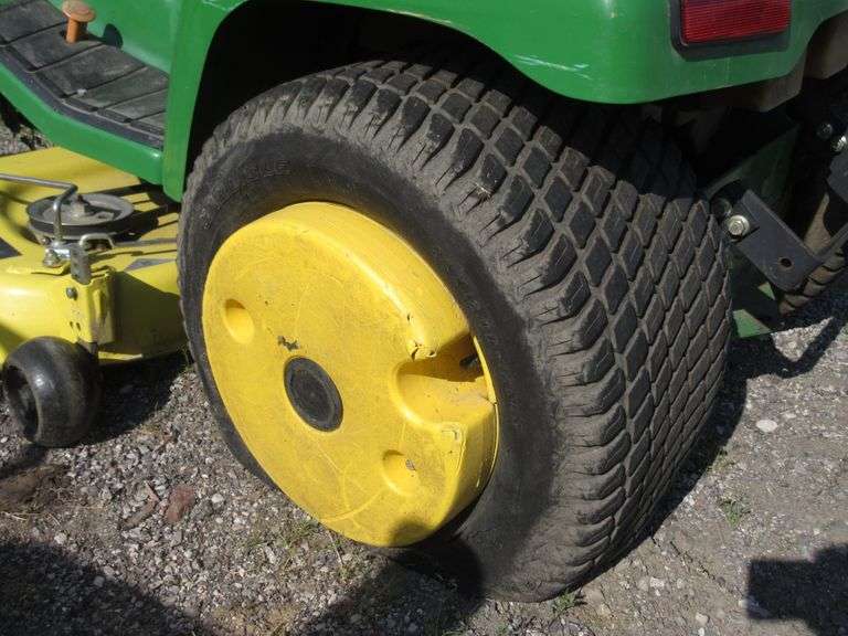 John Deere riding lawn mower, flat tire, no key, unknown condition