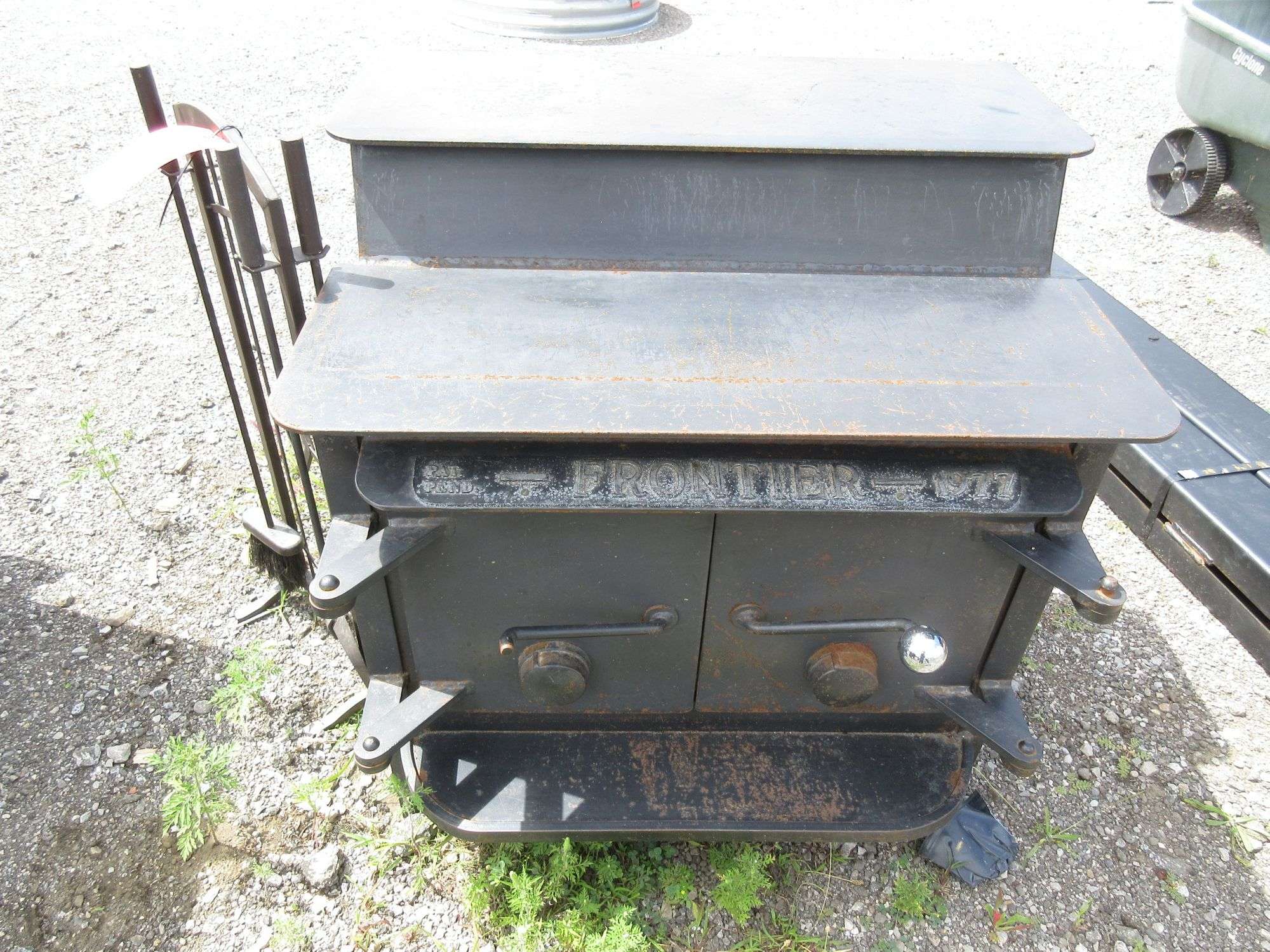 Frontier 1977 wood burning stove with 3-piece utensils, broom, and shovel,  stove- 32H x 20D, good, Attention: We can place this item on a flatbed  with our fork truck. The buyer will