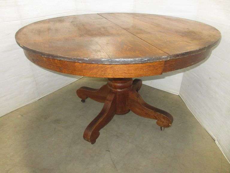 Antique tiger oak round table with wood casters, 48"Dia, some edge wear, otherwise good, very