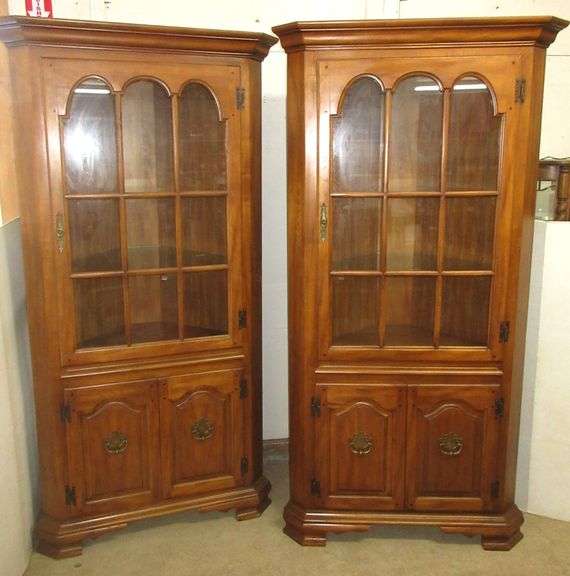 Pair of wood corner hutches with glass pane doors and two glass shelves