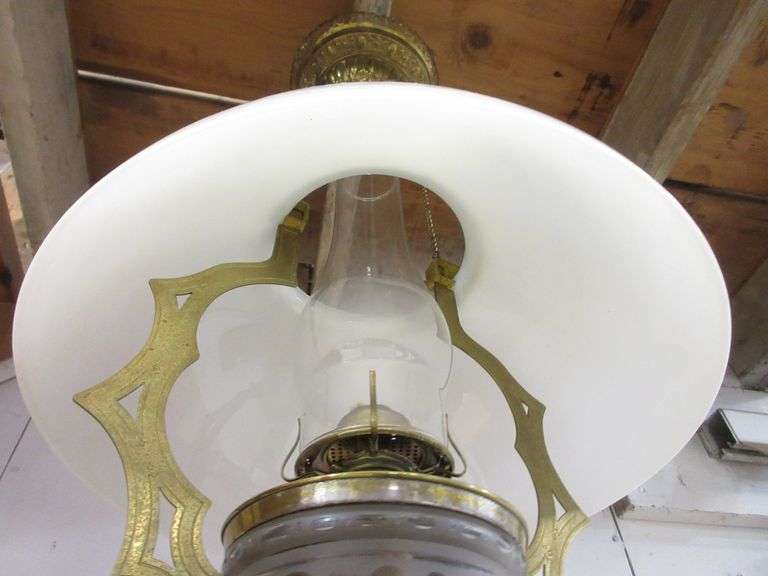 Antique hanging oil kerosene lamp, circa 1890's, has brass frame, milk