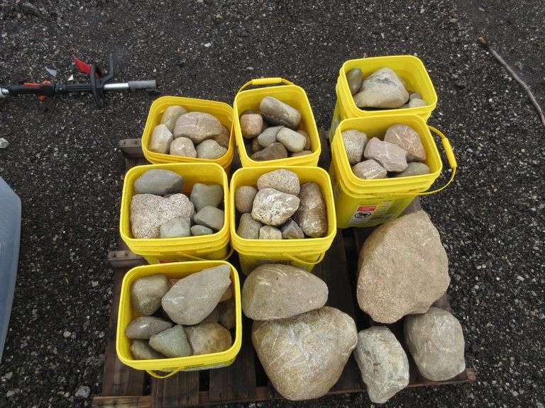 (7) Buckets of rocks and a large rock on pallet; Attention We can