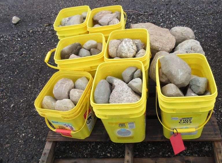 (7) Buckets of rocks and a large rock on pallet; Attention We can