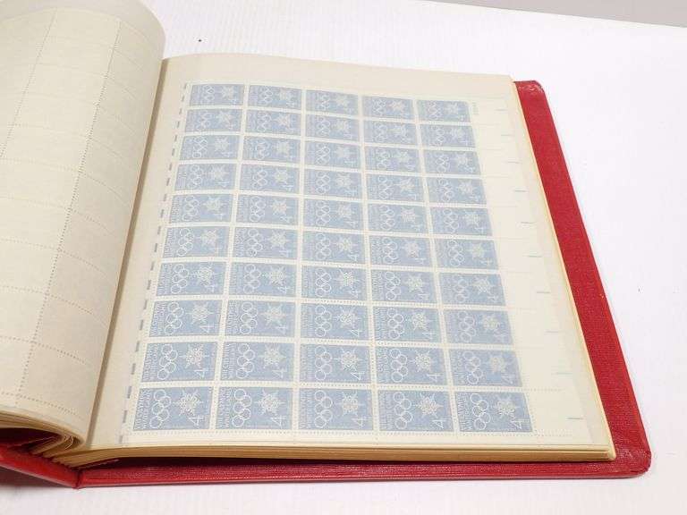 Collection of US mint never hinged stamp full sheets in a red and white