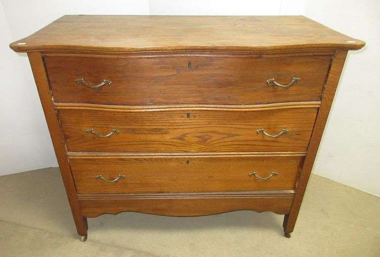 Oak threedrawer antique dresser, missing one caster, some top wear, 40