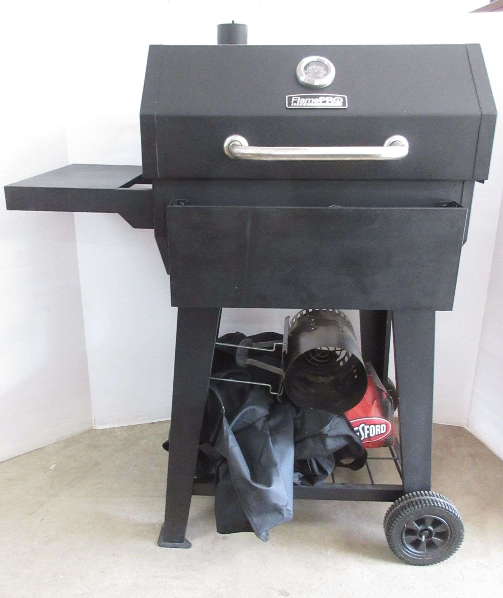 Dyna-Glo flame pro charcoal grill, includes: Stainless steel utensil set,  cover, and charcoal starter, 37W, good - Albrecht Auction Service
