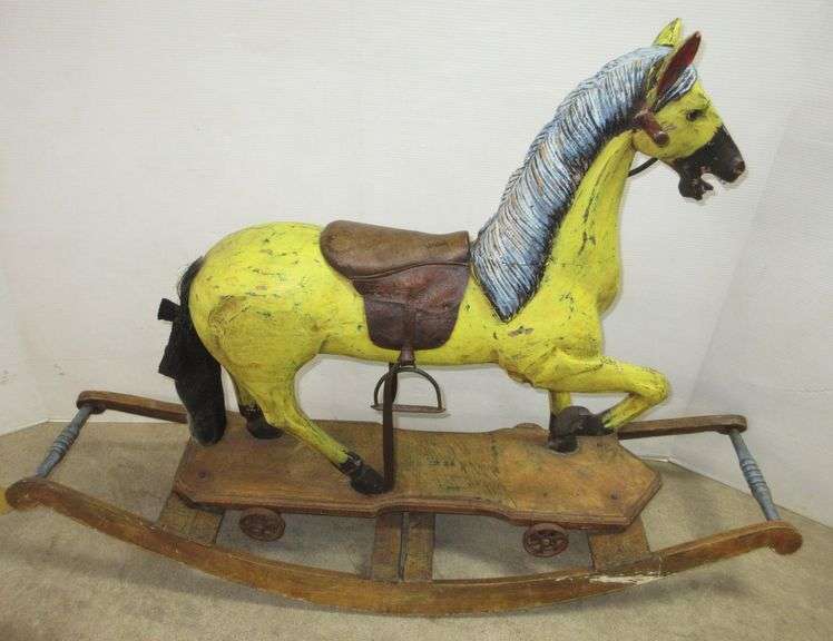 Carved wood rocking horse with original horse hair tail, glass eyes