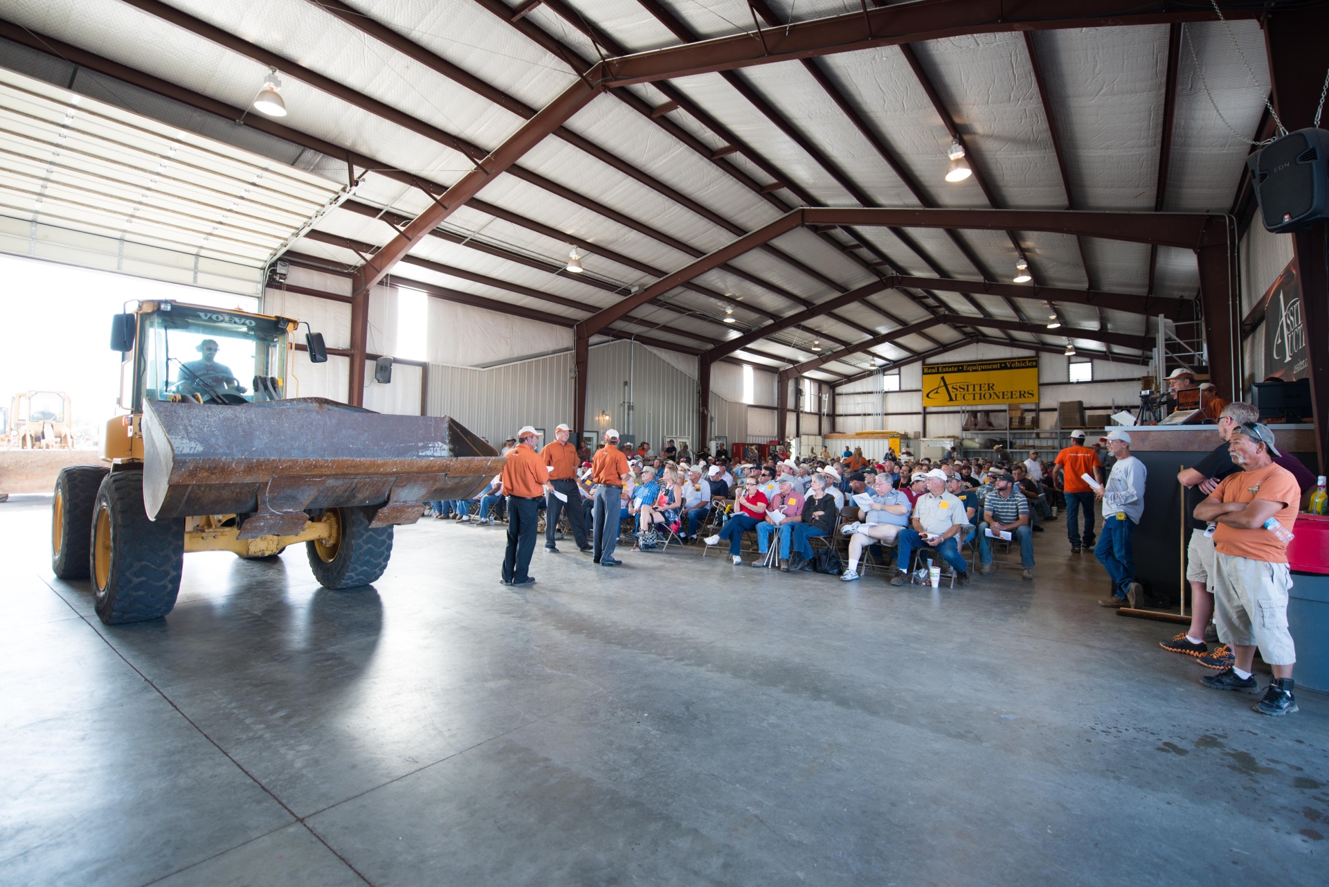 Auction crowd with heavy equipment