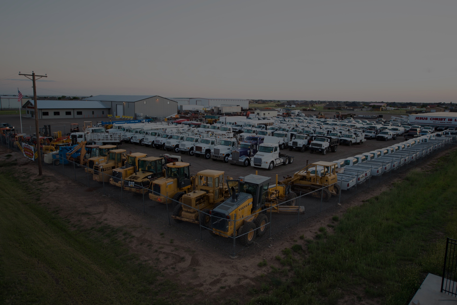 Assiter Auctioneers trucks and warehouse at dusk