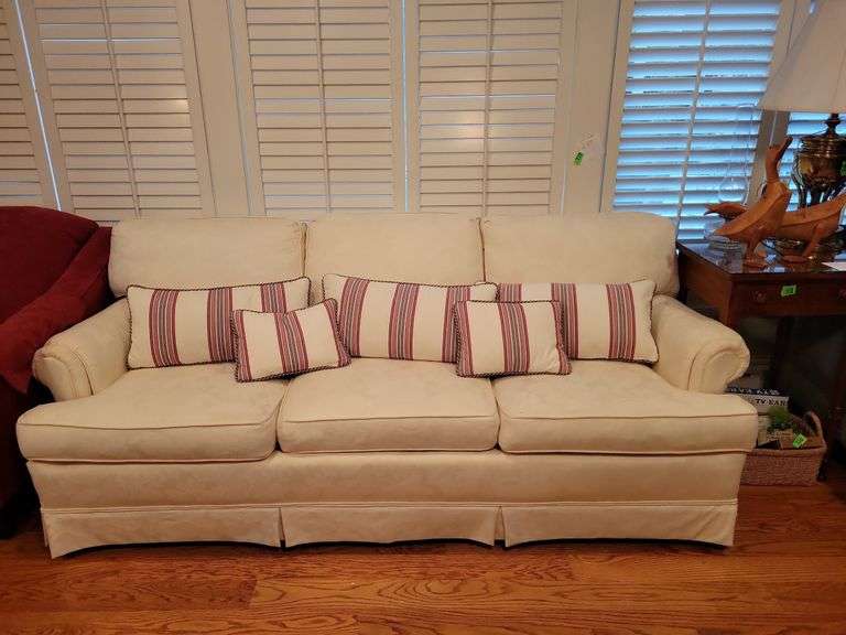 Cream Couch & pillows Baker Auctions & Real Estate, LLC