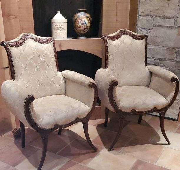 Two mahogany draped fireside chairs legs are loose have wear.. lower