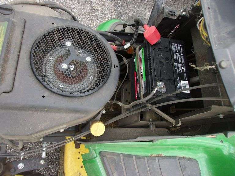 John Deere X310 lawn tractor with 42" deck, 214 hours, has crack in hood, new battery