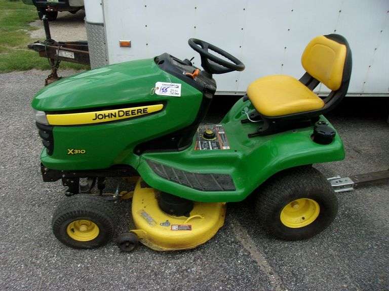 John Deere X310 lawn tractor with 42" deck, 214 hours, has crack in hood, new battery