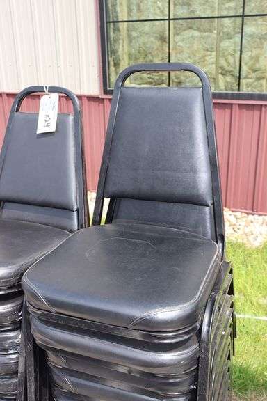 Times 24 - Black metal framed black vinyl seat & back padded stack chairs - minor rips & knicks on edges - overall good looking chairs