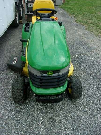 John Deere X310 lawn tractor with 42" deck, 214 hours, has crack in hood, new battery