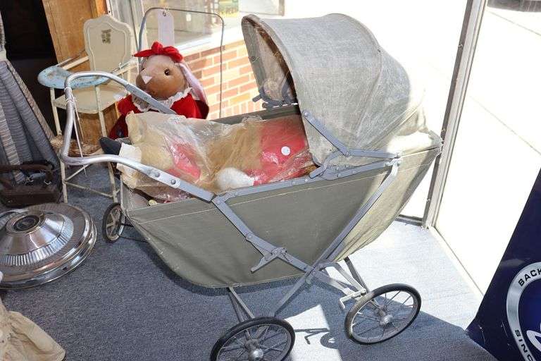 Vintage baby carriage with doll
