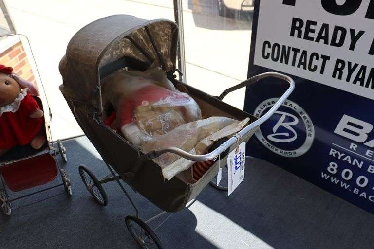 Vintage baby carriage with doll