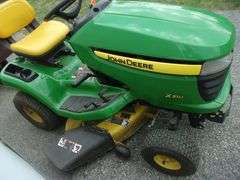John Deere X310 lawn tractor with 42" deck, 214 hours, has crack in hood, new battery