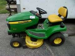 John Deere X310 lawn tractor with 42" deck, 214 hours, has crack in hood, new battery