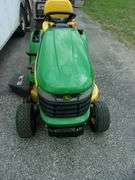 John Deere X310 lawn tractor with 42" deck, 214 hours, has crack in hood, new battery