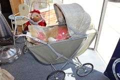Vintage baby carriage with doll