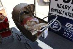 Vintage baby carriage with doll