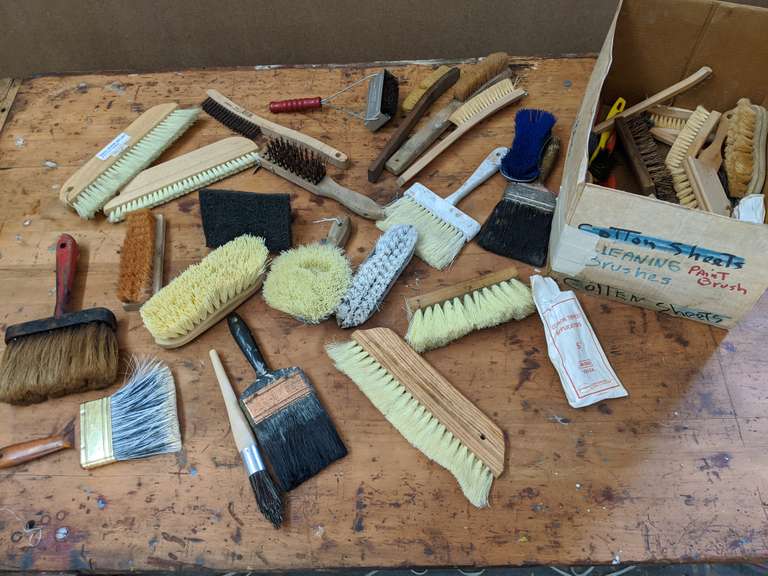 box filled with paint and scrub brushes Bid On Estates Auction Services