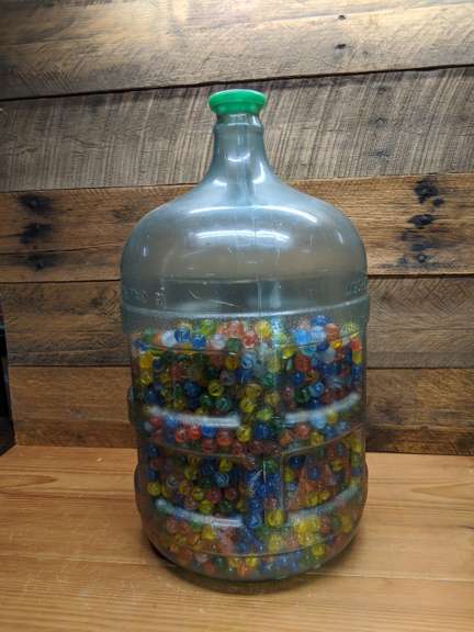 Approximately 3 Gallons Of Marbles In A Plastic Water Jug Bid On Estates