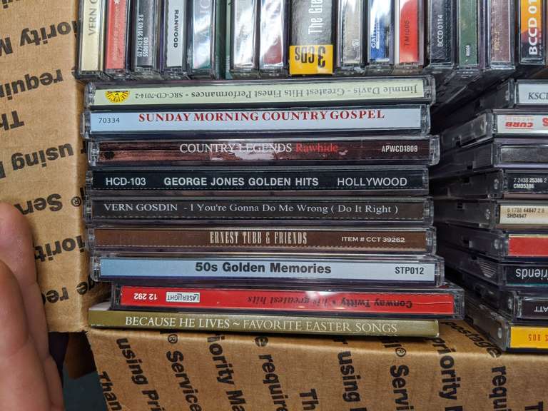2 boxes of cds (mostly country) Bid On Estates Auction Services