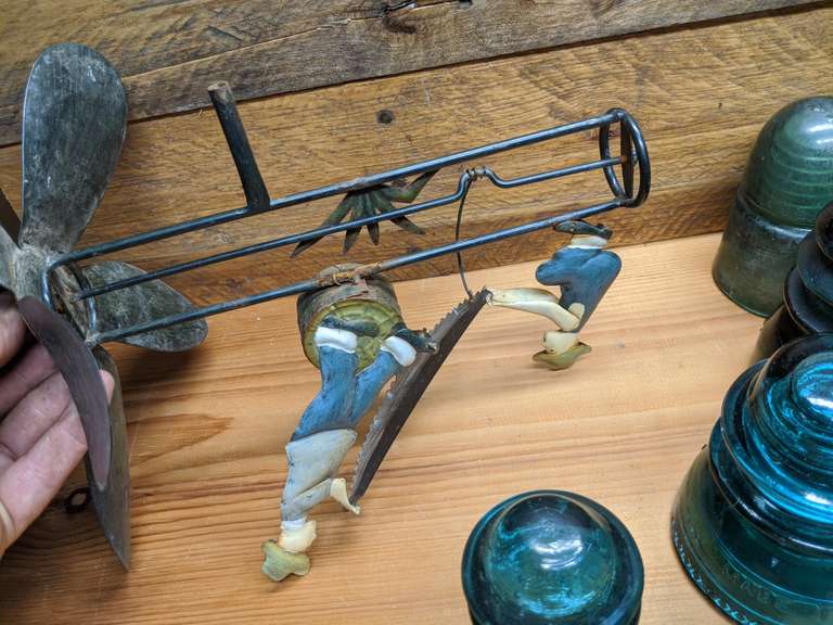 glass insulators and tin whirlygig Bid On Estates Auction Services