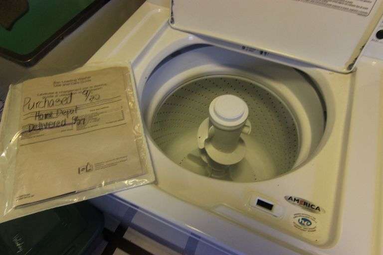 Amana top loading washer, model NTW4516FW0, powered on. ByceAUCTION