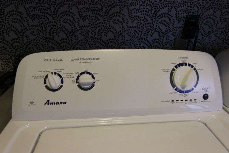 Amana top loading washer, model NTW4516FW0, powered on. ByceAUCTION