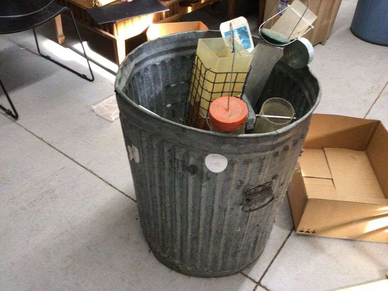 GALVANIZED TRASH CAN WITH VARIOUS BIRD FEEDERS Currie Auction Service