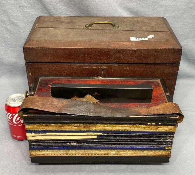 Antique squeezebox instrument in early dovetailed walnut carrying case