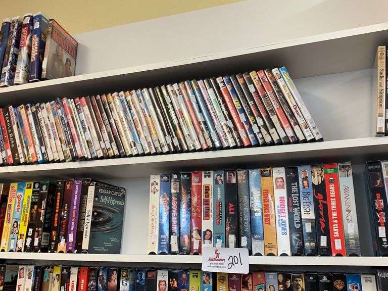 (2) SHELVING UNITS W/ MISC. VHS TAPES & DVDS EK Auctioneers LLC