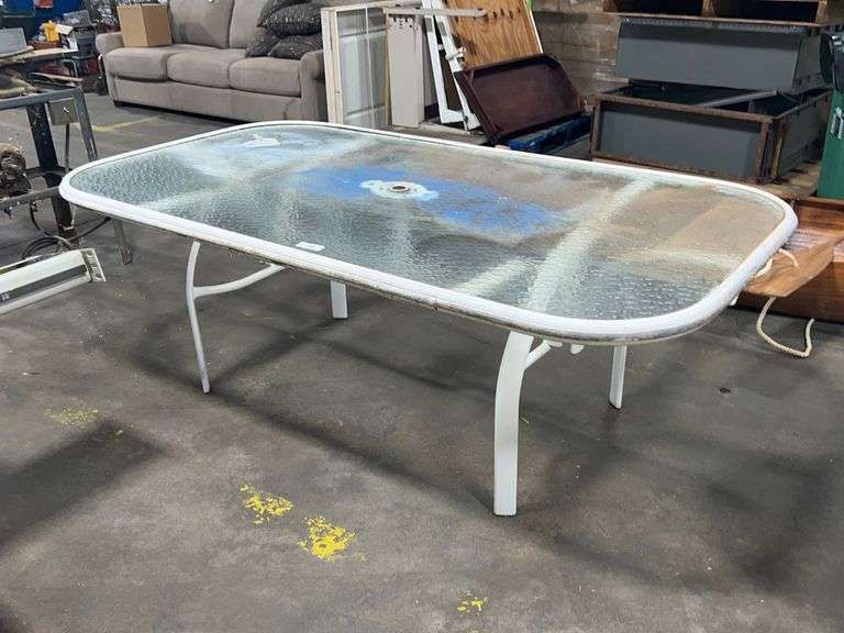 Glass top patio table Auction Services LTD