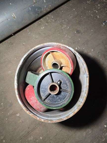 BUCKET OF METAL WHEELS WITH RUBBER.