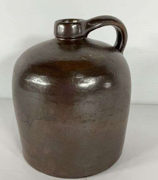 Brown pottery glazed whiskey jug, no markings, 8 in tall Hash Auctions