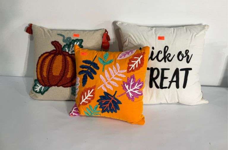 Three autumn themed throw pillows, one has tags Hash Auctions