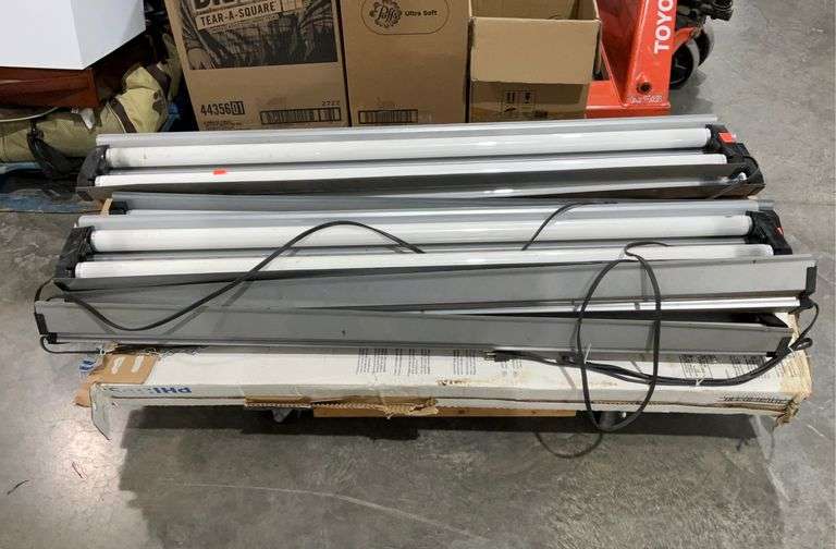 Group of 49.5in long ballasts and fluorescent light bulbs, wheeled cart