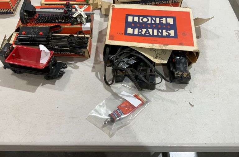 Lionel train group, includes train cars, coal loader, lubricant, light