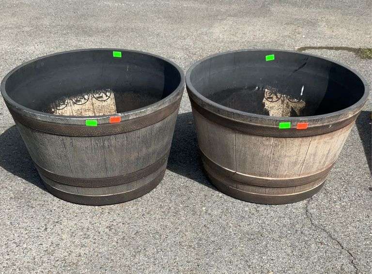 Pair of poly barrel style planters 23”dia, holes drilled in bottoms