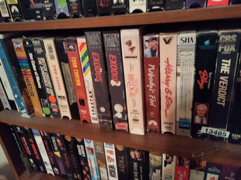 SHELF OF VHS TAPES Dallas Online Auction Company