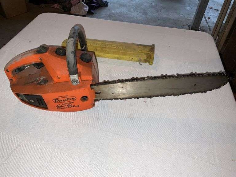 Dayton 12 inch chainsaw. Has compression Legacy Auction Company