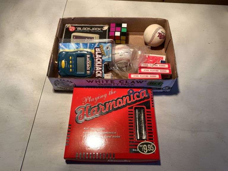Games, harmonica, baseballs, etc. Legacy Auction Company