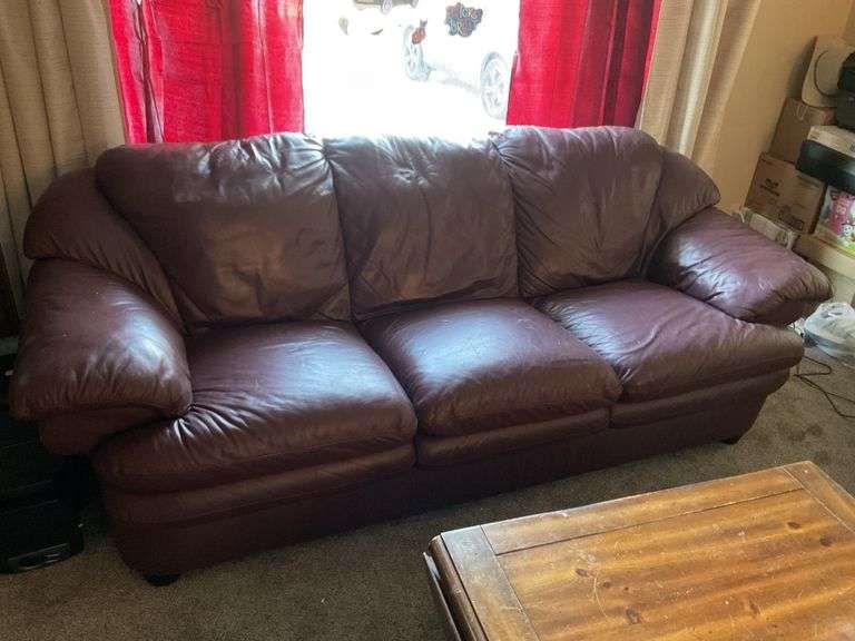 Burgundy leather sofa. 92 in x 40 Legacy Auction Company